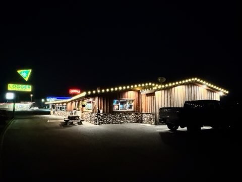 Restaurant roofline outlined in warm white lights at night