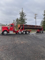 Log truck in daylight before the lights go on