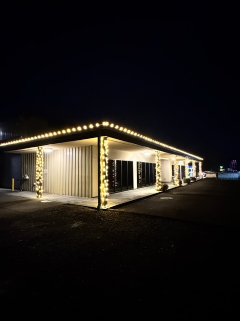 Commercial building with warm white roofline and column lighting